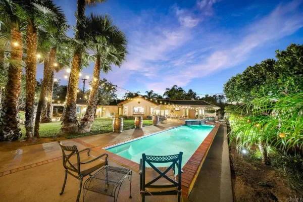 a view of swimming pool with lounge chairs