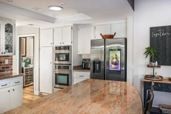 a kitchen with stainless steel appliances a stove a sink and a refrigerator