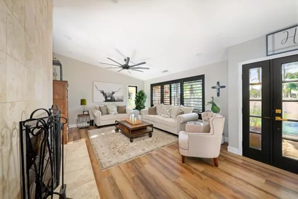 a living room with furniture a flat screen tv and a large window