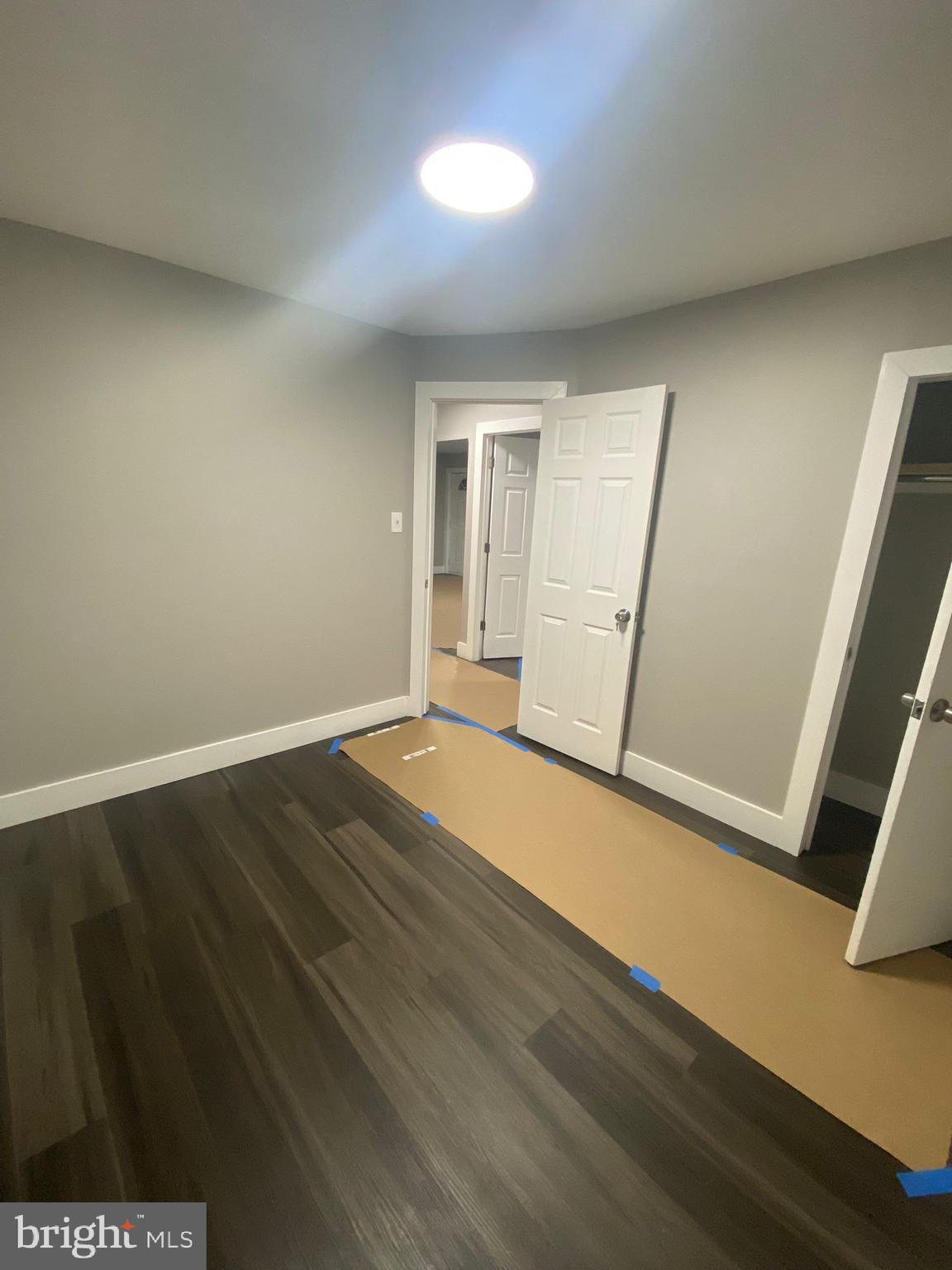 203 Kinsley Road Pemberton, NJ 08068 - Photo 2 of 9 an empty room with wooden floor and window