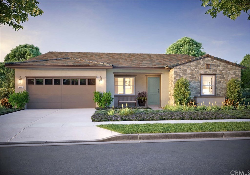 a front view of a house with a yard and a garage