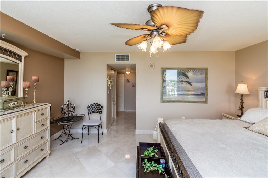 2001 North Ocean Boulevard, Unit 804 Fort Lauderdale, FL 33305 - Photo 13 of 42 a bedroom with furniture and a chandelier