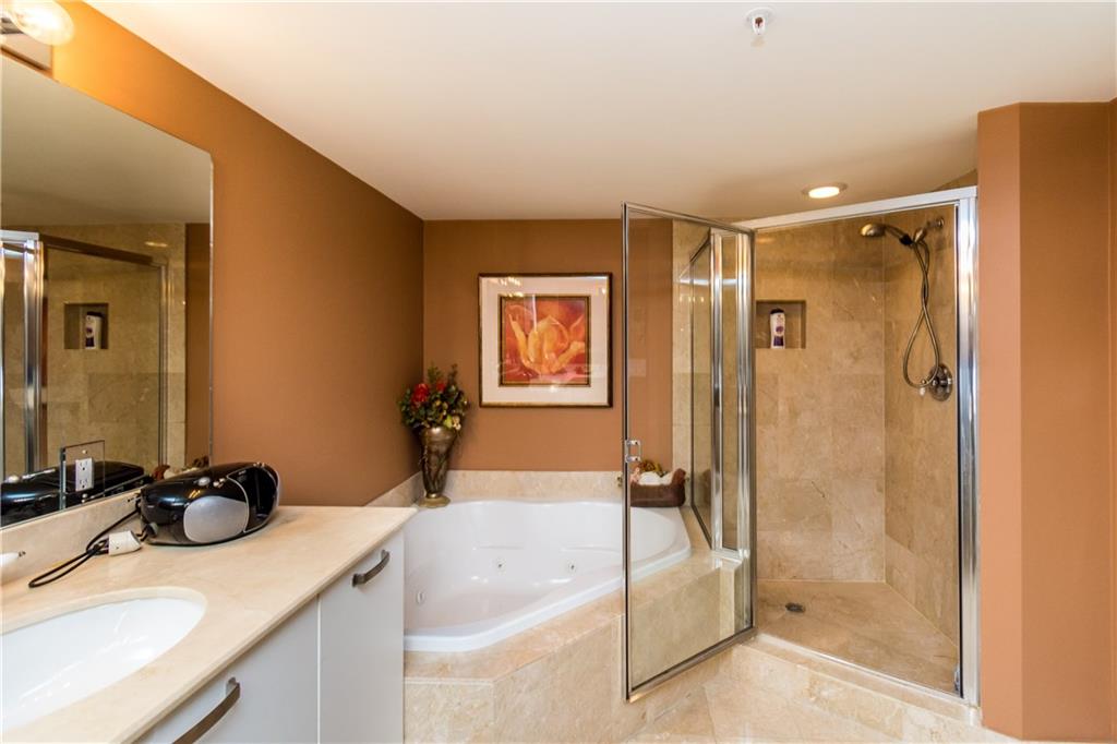 2001 North Ocean Boulevard, Unit 804 Fort Lauderdale, FL 33305 - Photo 14 of 42 a bathroom with a tub sink and mirror