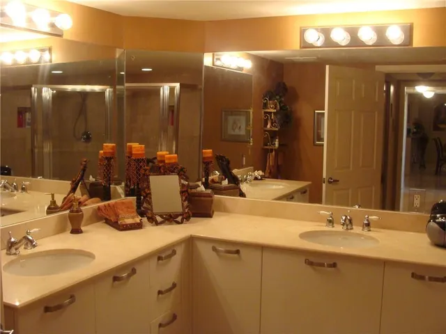 a bathroom with a double vanity sink and a mirror
