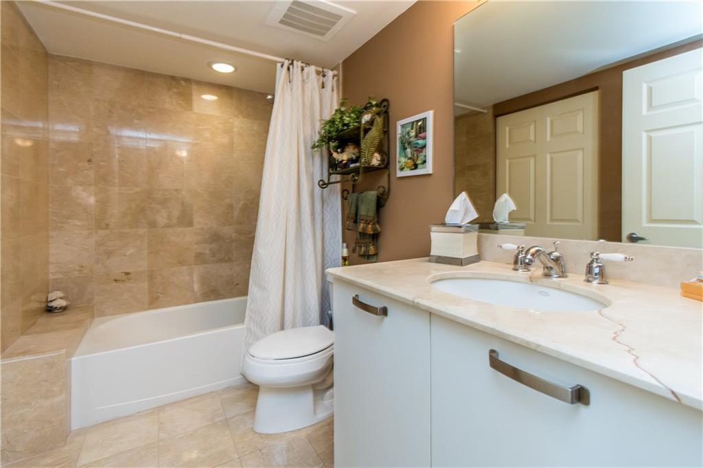 2001 North Ocean Boulevard, Unit 804 Fort Lauderdale, FL 33305 - Photo 20 of 42 a bathroom with a granite countertop sink a toilet and shower