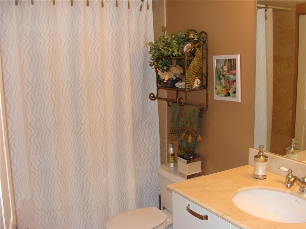 2001 North Ocean Boulevard, Unit 804 Fort Lauderdale, FL 33305 - Photo 21 of 42 a bathroom with a granite countertop sink and a mirror
