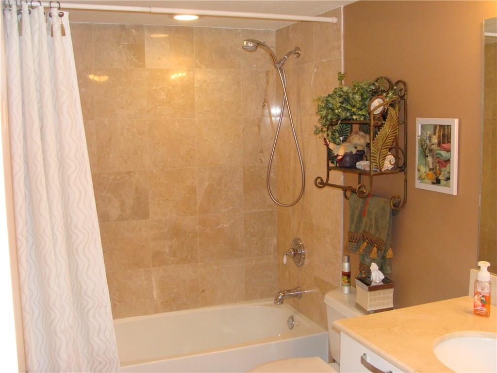 2001 North Ocean Boulevard, Unit 804 Fort Lauderdale, FL 33305 - Photo 22 of 42 a bathroom with a shower curtain and a sink