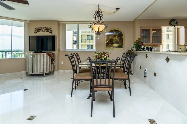 a view of a dining room with furniture and a chandelier