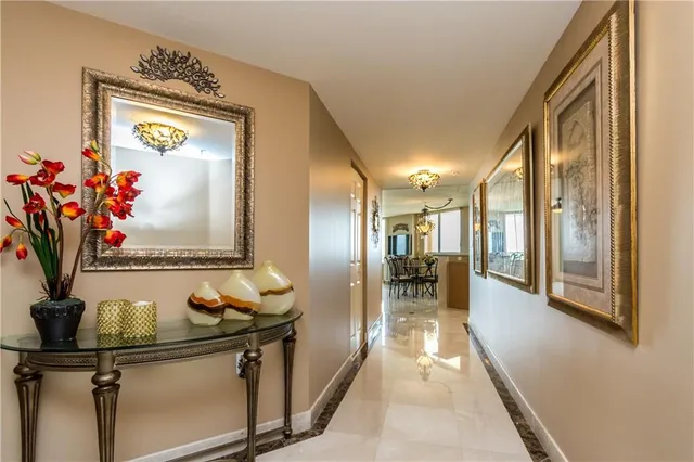a view of a hallway with a dining table and chairs