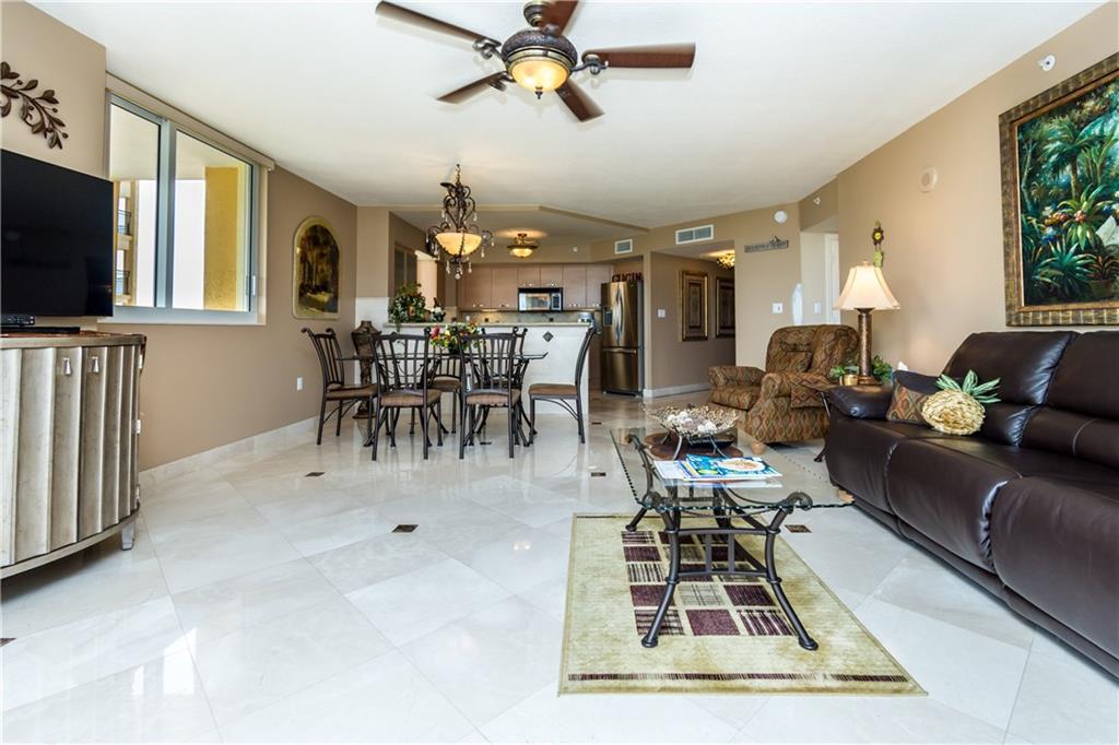 2001 North Ocean Boulevard, Unit 804 Fort Lauderdale, FL 33305 - Photo 10 of 42 a living room with lots of furniture and a view of kitchen
