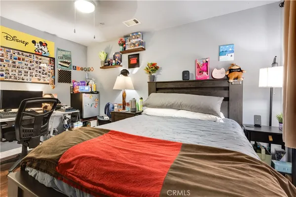 a bed room with a bed and a chair