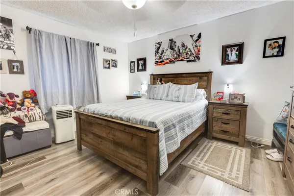 a large bed sitting in a bedroom next to a couch and a window