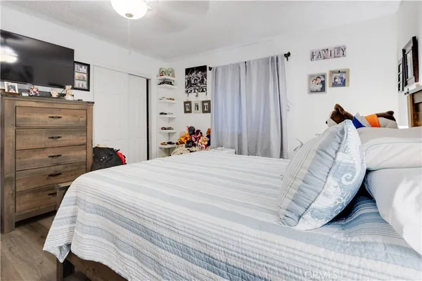 a bedroom with a bed and a flat screen tv
