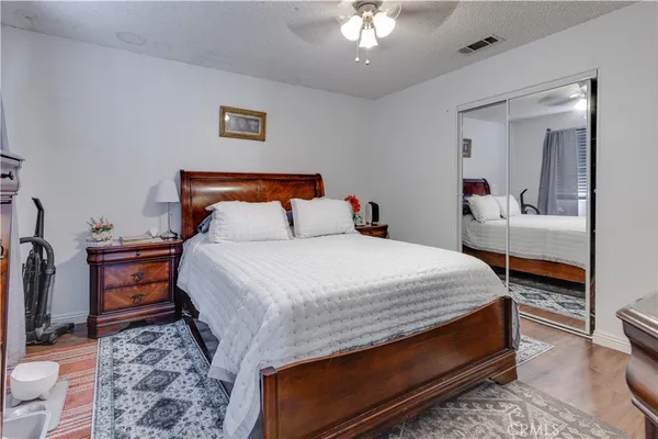 a bedroom with bed and wooden floor