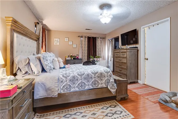 a bedroom with a bed dresser and a window
