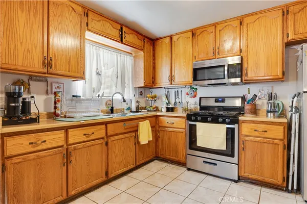 a kitchen with stainless steel appliances granite countertop a stove sink and cabinets