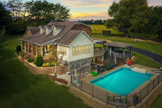 an aerial view of a house with swimming pool garden and patio