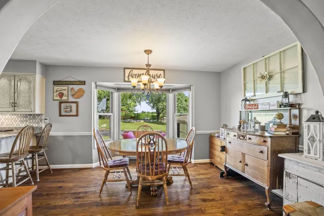 a view of a dining room and hall with wooden floor