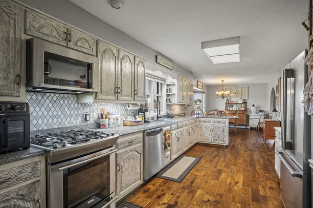 a bathroom with a sink a toilet and a window