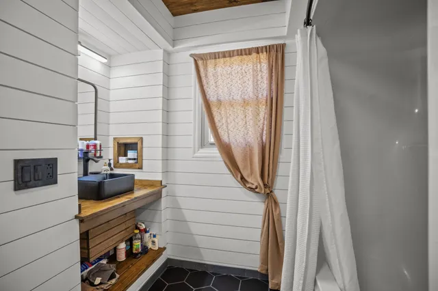 a bedroom with furniture and a flat screen tv