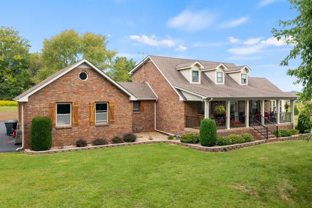 a living room with furniture a chandelier and a large window