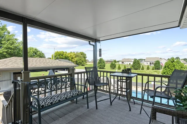 an outdoor sitting area with a table and chairs