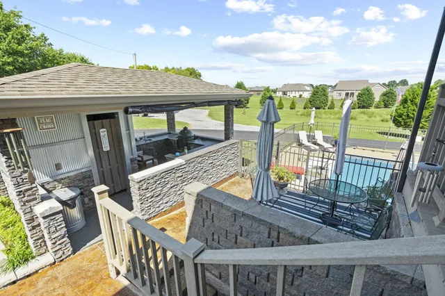 a view of a swimming pool with an outdoor seating and a garden