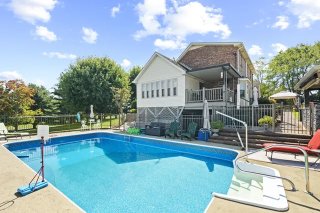 a view of a patio with a table chairs and a backyard
