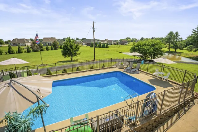 a view of backyard with deck and seating area