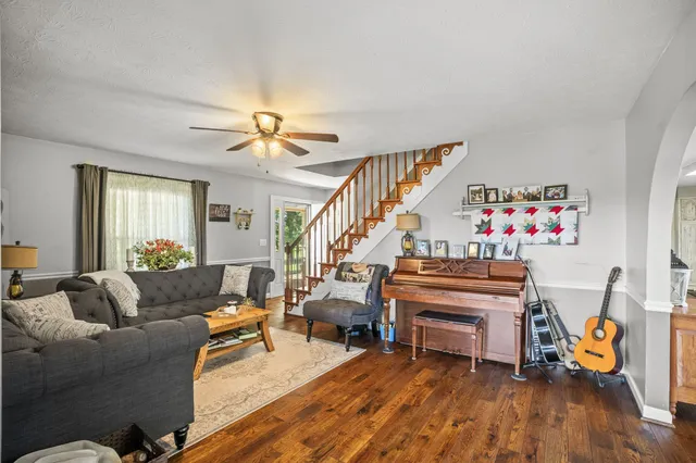 a living room with furniture and a piano