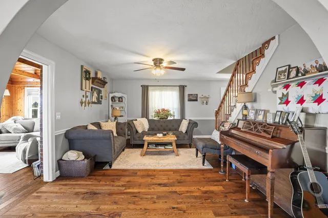 a living room with furniture and floor to ceiling windows