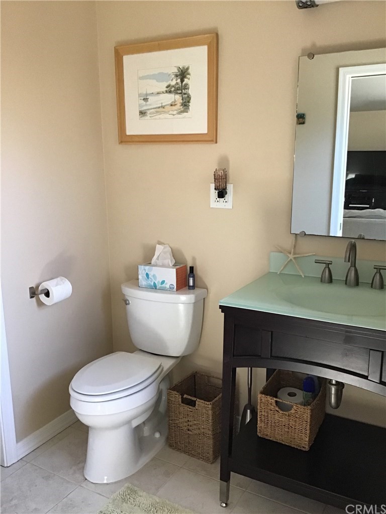 2154 Ostrom Avenue Long Beach, CA 90815 - Photo 13 of 29 a bathroom with a toilet a sink and mirror