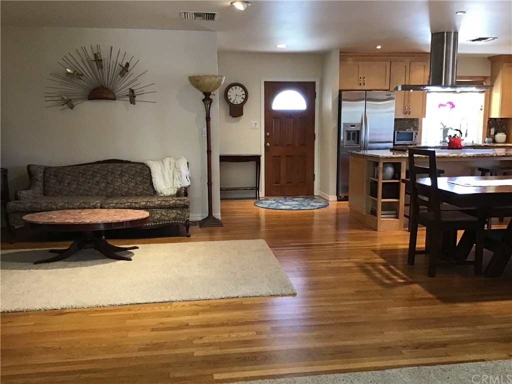 2154 Ostrom Avenue Long Beach, CA 90815 - Photo 15 of 29 a living room with stainless steel appliances kitchen island granite countertop furniture and a view of kitchen