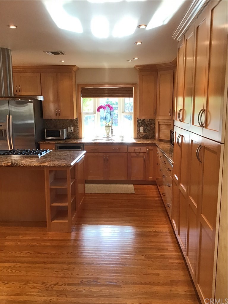 2154 Ostrom Avenue Long Beach, CA 90815 - Photo 5 of 29 a kitchen with stainless steel appliances a stove a sink and a refrigerator
