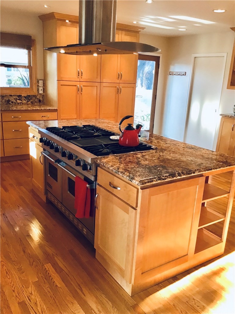 2154 Ostrom Avenue Long Beach, CA 90815 - Photo 7 of 29 a kitchen with stainless steel appliances granite countertop a stove a sink and a refrigerator