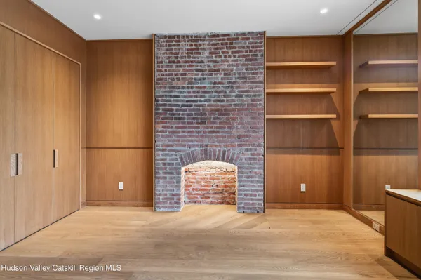 a view of an empty room with cabinet and a window