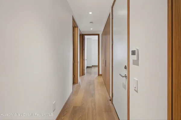 a view of a hallway with wooden floor