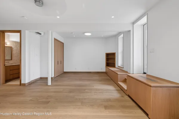 a view of a hallway with wooden floor and staircase