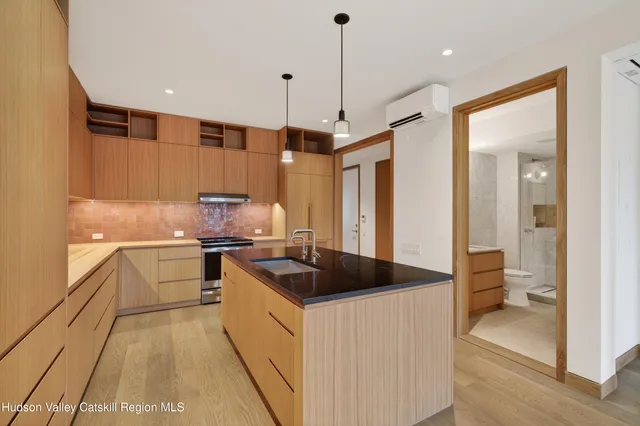 a kitchen with a sink stove and refrigerator