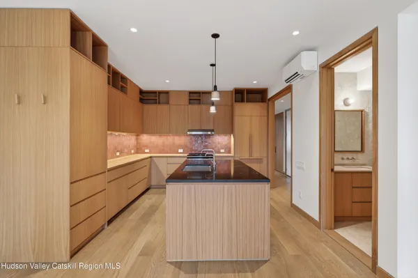 a kitchen with refrigerator and cabinets