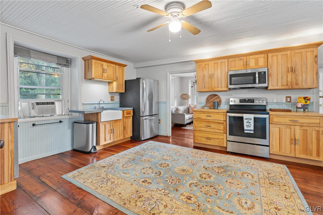 3225 Jordan Road Orefield, PA 18069 - Photo 14 of 50 a kitchen with stainless steel appliances granite countertop a stove top oven a refrigerator a sink and dishwasher with a dining table