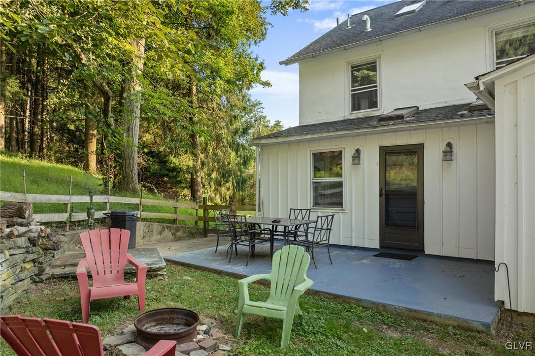 3225 Jordan Road Orefield, PA 18069 - Photo 41 of 50 a patio table and chairs with potted plants and a fountain