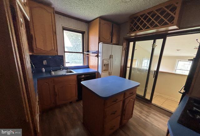 526 Manor Road Beverly, NJ 08010 - Photo 6 of 13 a kitchen with stainless steel appliances granite countertop a refrigerator a sink a stove a microwave oven and a dining table with wooden floor