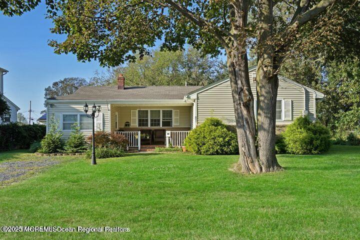 a view of a house with a yard and sitting area