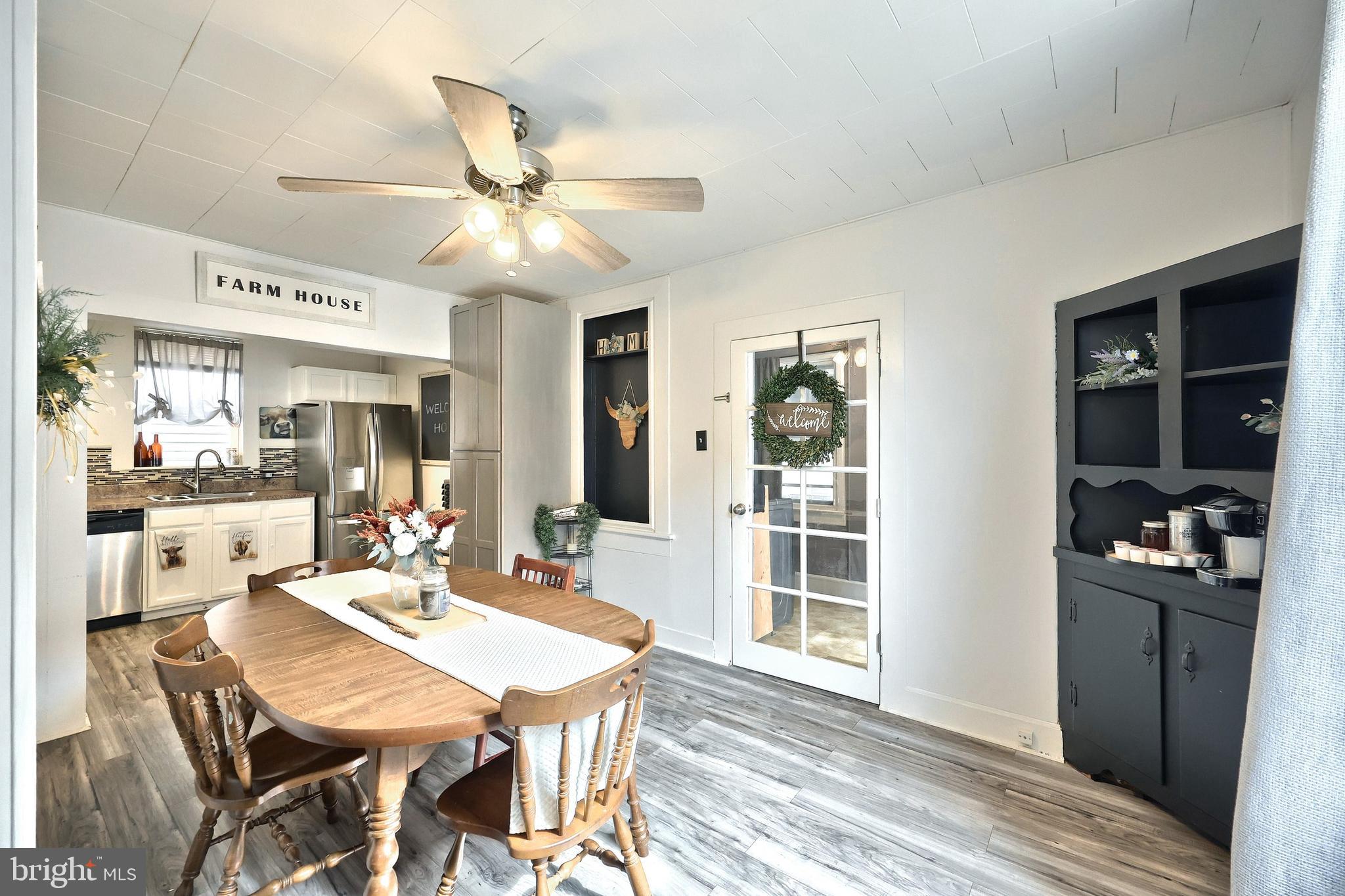 416 South High Street Hanover, PA 17331 - Photo 19 of 37 a dining room with wooden floor a chandelier fan a wooden table and chairs