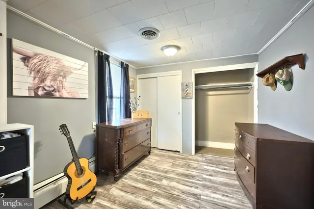 a bathroom with a sink a toilet a mirror and shower