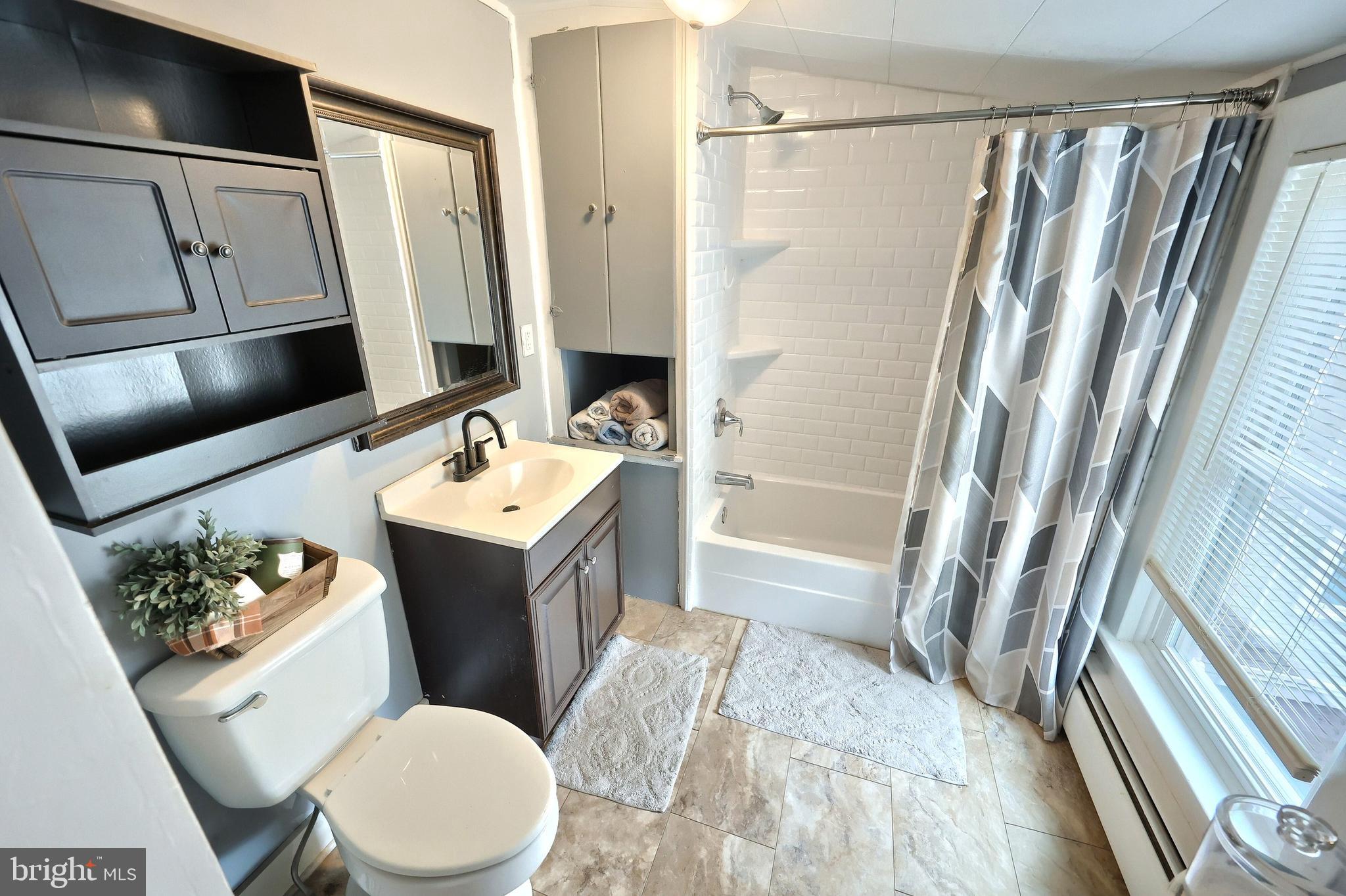 416 South High Street Hanover, PA 17331 - Photo 31 of 37 a bathroom with a sink a toilet a mirror and shower