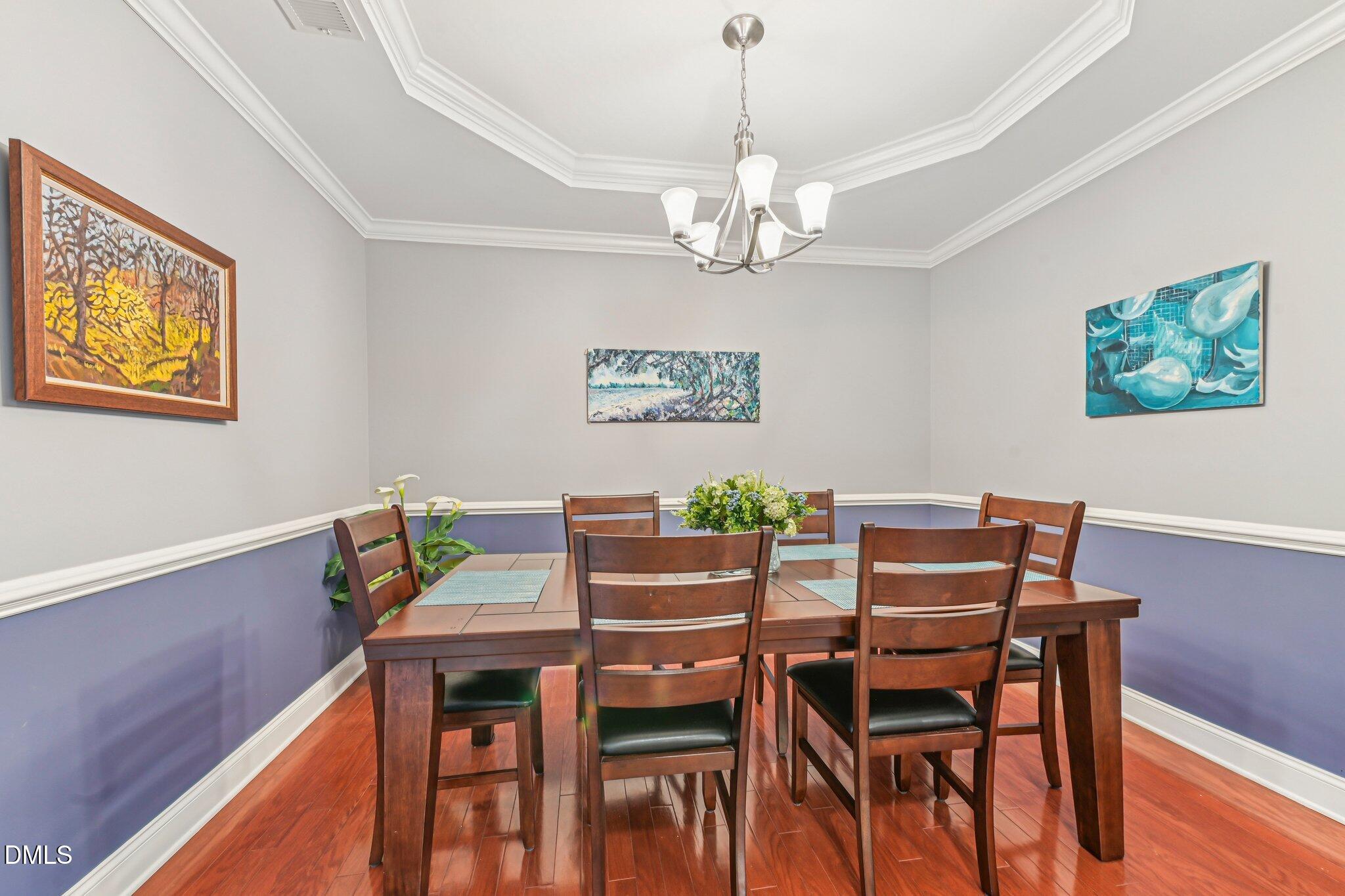 10411 Rosegate Court, Unit 205 Raleigh, NC 27617 - Photo 15 of 38 a view of a dining room with furniture wooden floor and a chandelier