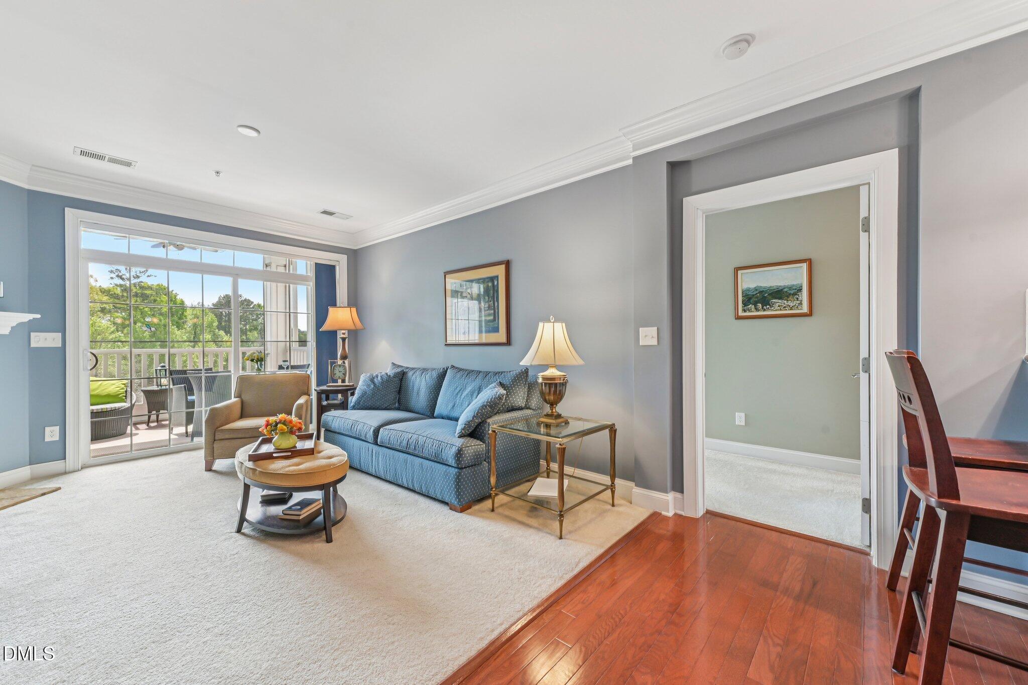 10411 Rosegate Court, Unit 205 Raleigh, NC 27617 - Photo 16 of 38 a living room with furniture and a large window