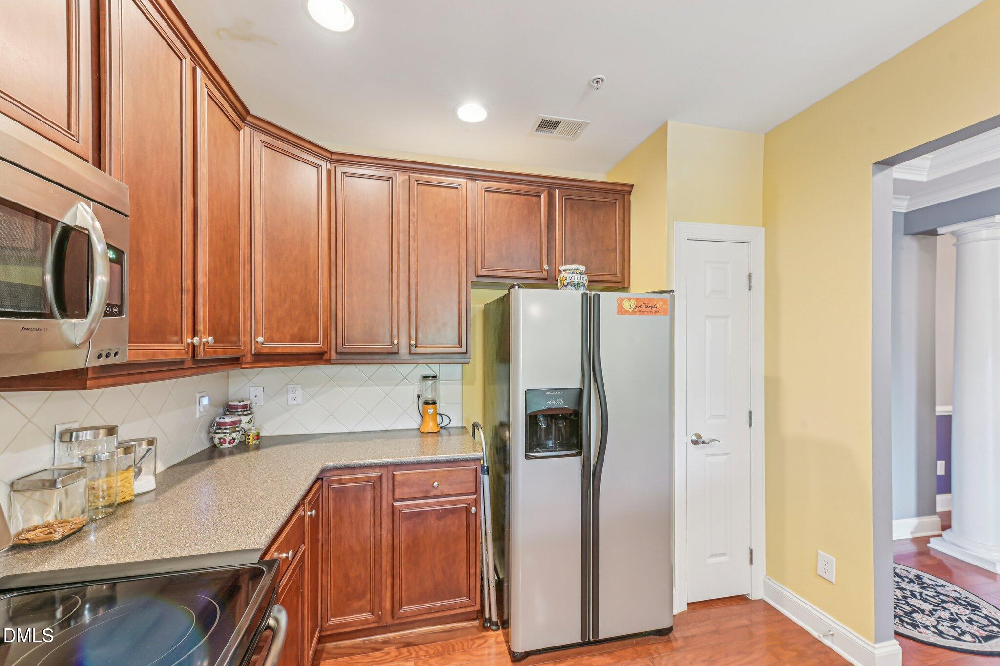 10411 Rosegate Court, Unit 205 Raleigh, NC 27617 - Photo 20 of 38 a kitchen with stainless steel appliances granite countertop a refrigerator and a sink